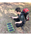 Beam Outback 11W solar panel powering gear on a hiker's backpack on the trail thumbnail