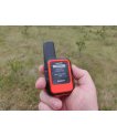 Garmin inReach Mini in orange held in hand outdoors thumbnail