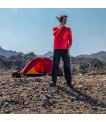 Hiker making a call on an Inmarsat IsatPhone 2 rental beside a tent in the mountains thumbnail